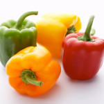 Four colorful bell peppers. Isolated on white background.  [url=http://www.istockphoto.com/file_search.php?action=file&lightboxID=3313862][img]http://santoriniphoto.com/Template-Chili.jpg[/img][/url]